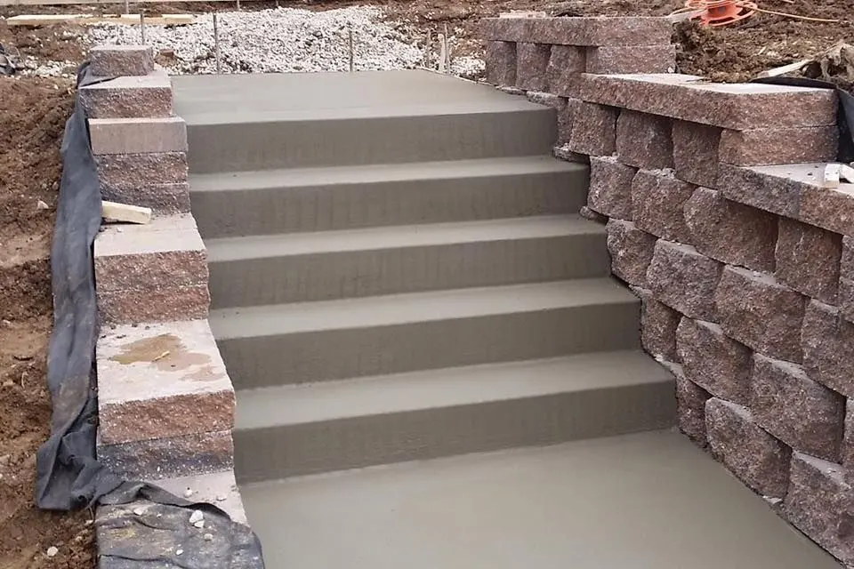 Concrete steps with retaining wall by J.D. James Construction